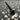 Black-nickel socket head cap screw from the Milo v1.5 fastener kit shown close up on a chip-covered mill surface