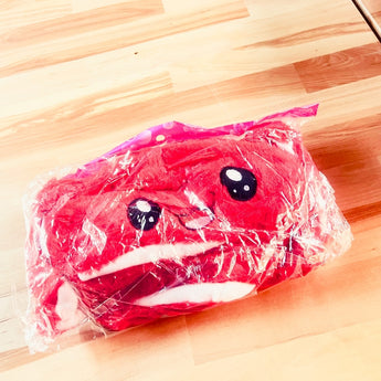 Red plush rabbit hat packaged in clear plastic with embroidered bunny face and white ear accents