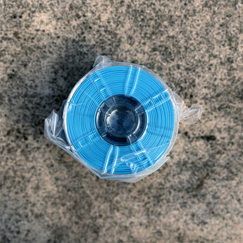 Sealed spool of Decent ASA-GF filament in Sky Blue, glass-fiber reinforced ASA for abrasive-nozzle 3D printing
