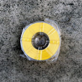 Yellow Decent ASA-GF glass-fiber reinforced ASA 3D printer filament spool sealed in plastic