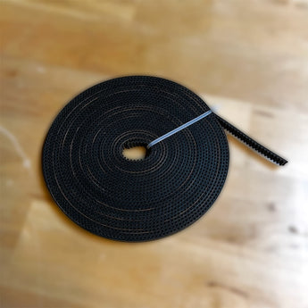 Coiled black Gates LL-3GT 9mm RF open timing belt with fiberglass-reinforced tooth profile
