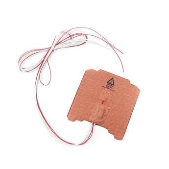 Small orange silicone bed heater with red and white wire leads on a white background
