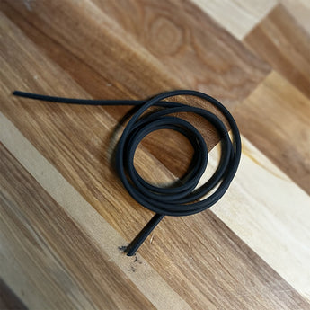 Black 2mm round sponge cord coiled on a wood surface, supplied as a 1m seal length
