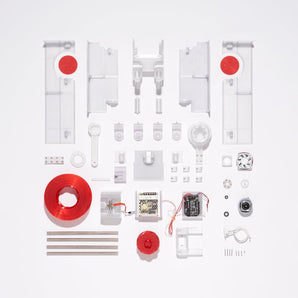 Polyformer kit components laid out with 3D printed panels, rods, electronics, motor, power supply, fan, wiring, bearings, and red spool
